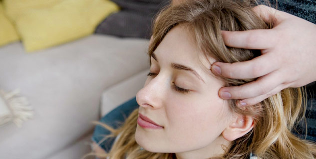 Grip the forehead and back of the head