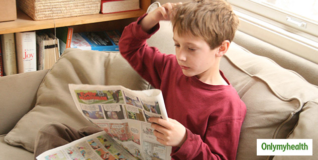 kid reading newspaper