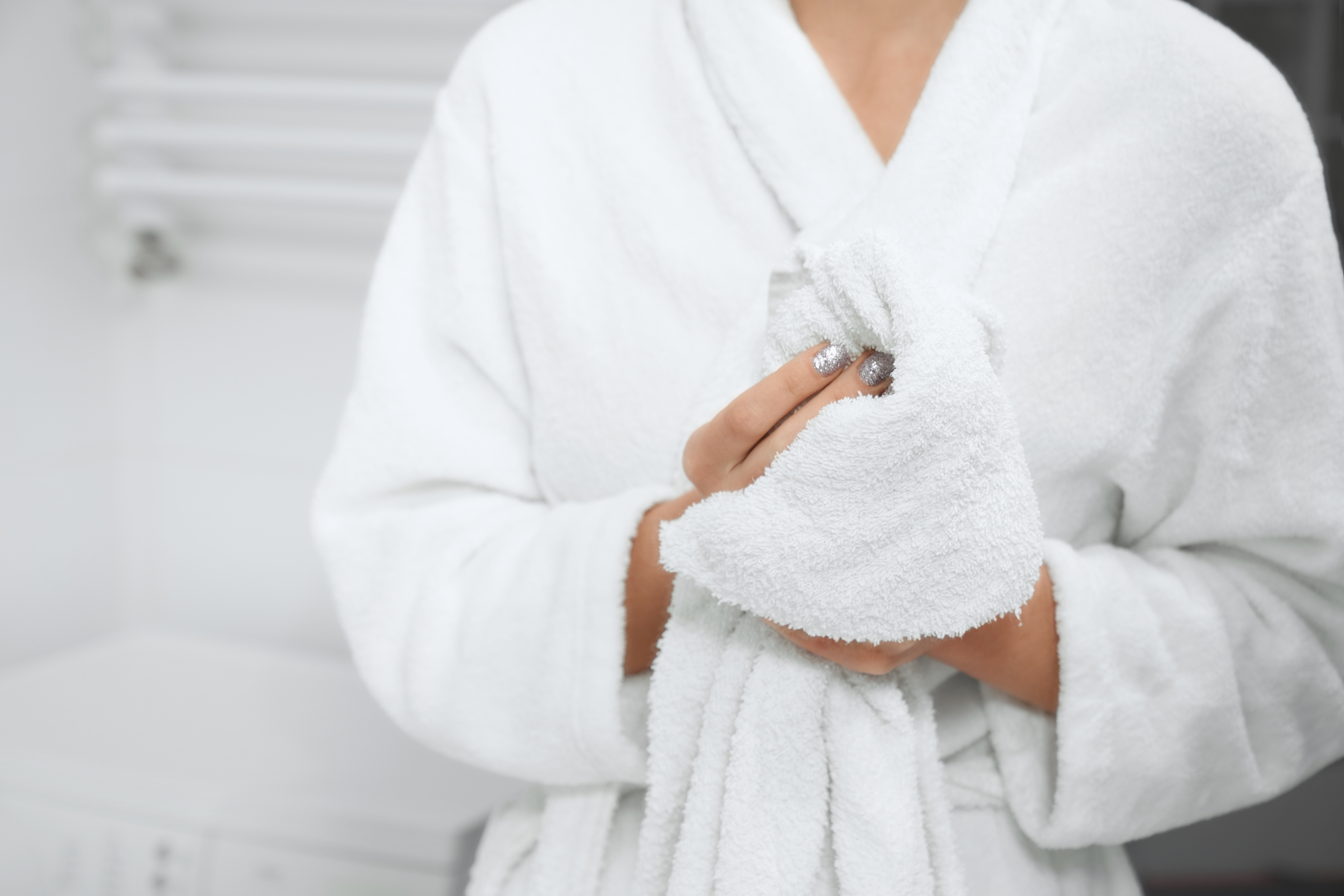 woman-robe-standing-bathroom-with-white-towel