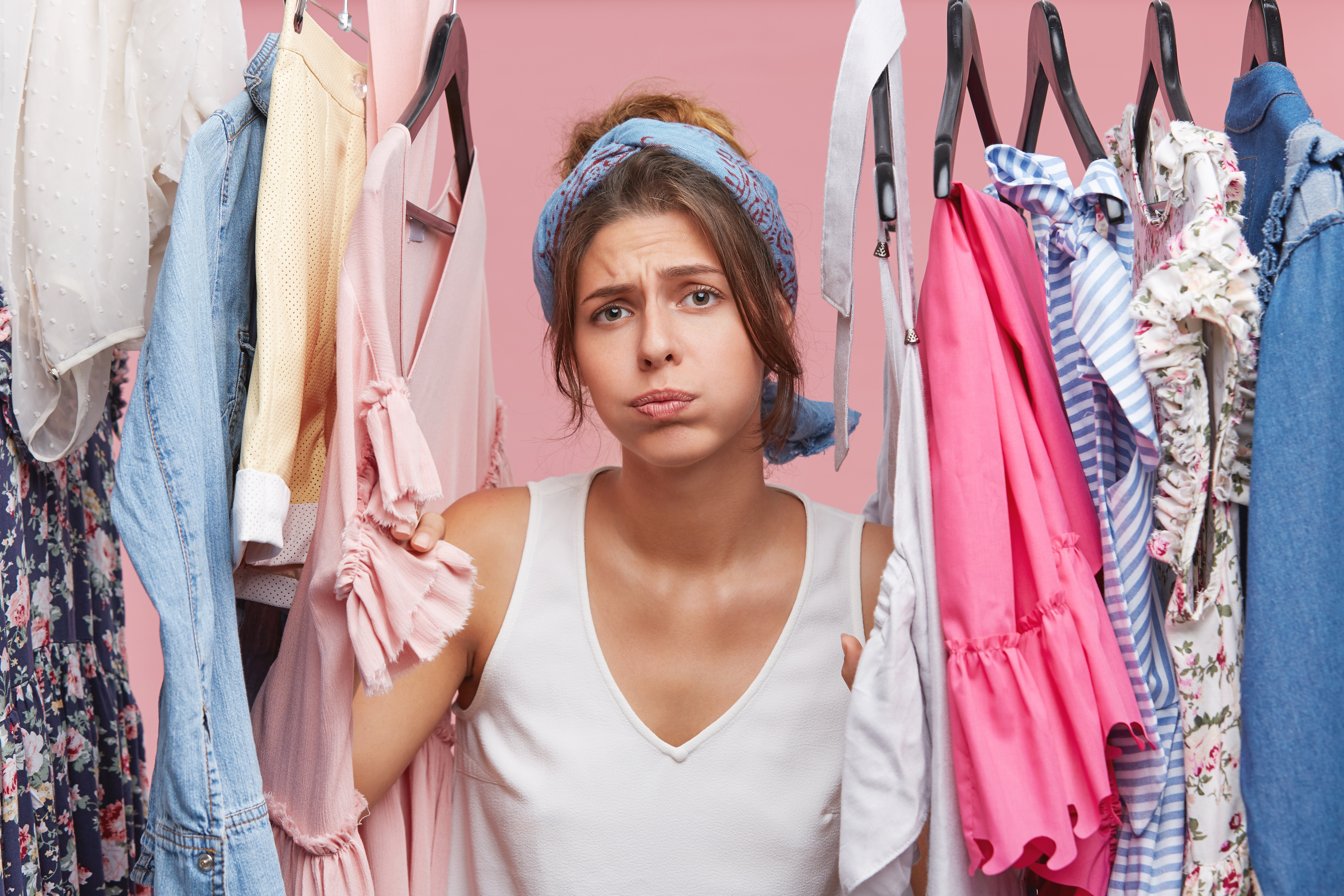 depressed-female-standing-near-wardrobe-rack-full-clothes-having-difficult-choice-knowing-what-put