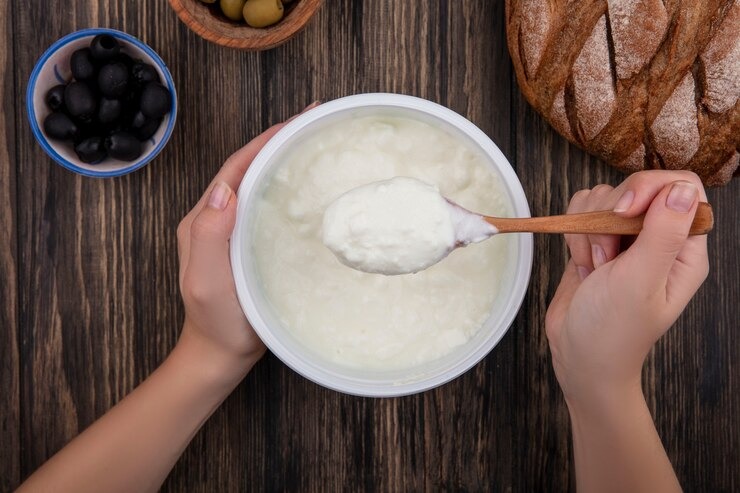 top-view-woman-eating-yogurt-bow